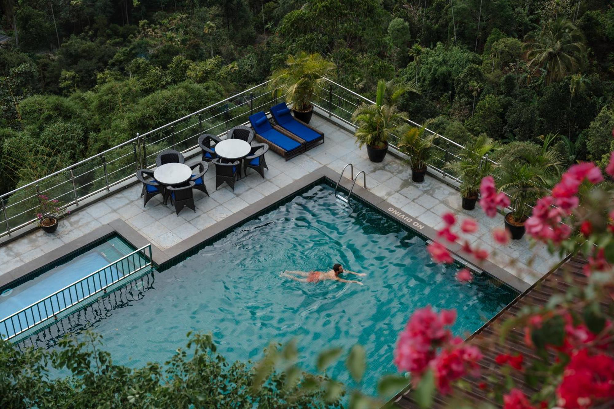 The Panoramic Getaway Hotel Munnar Exterior photo The swimming pool at the hotel