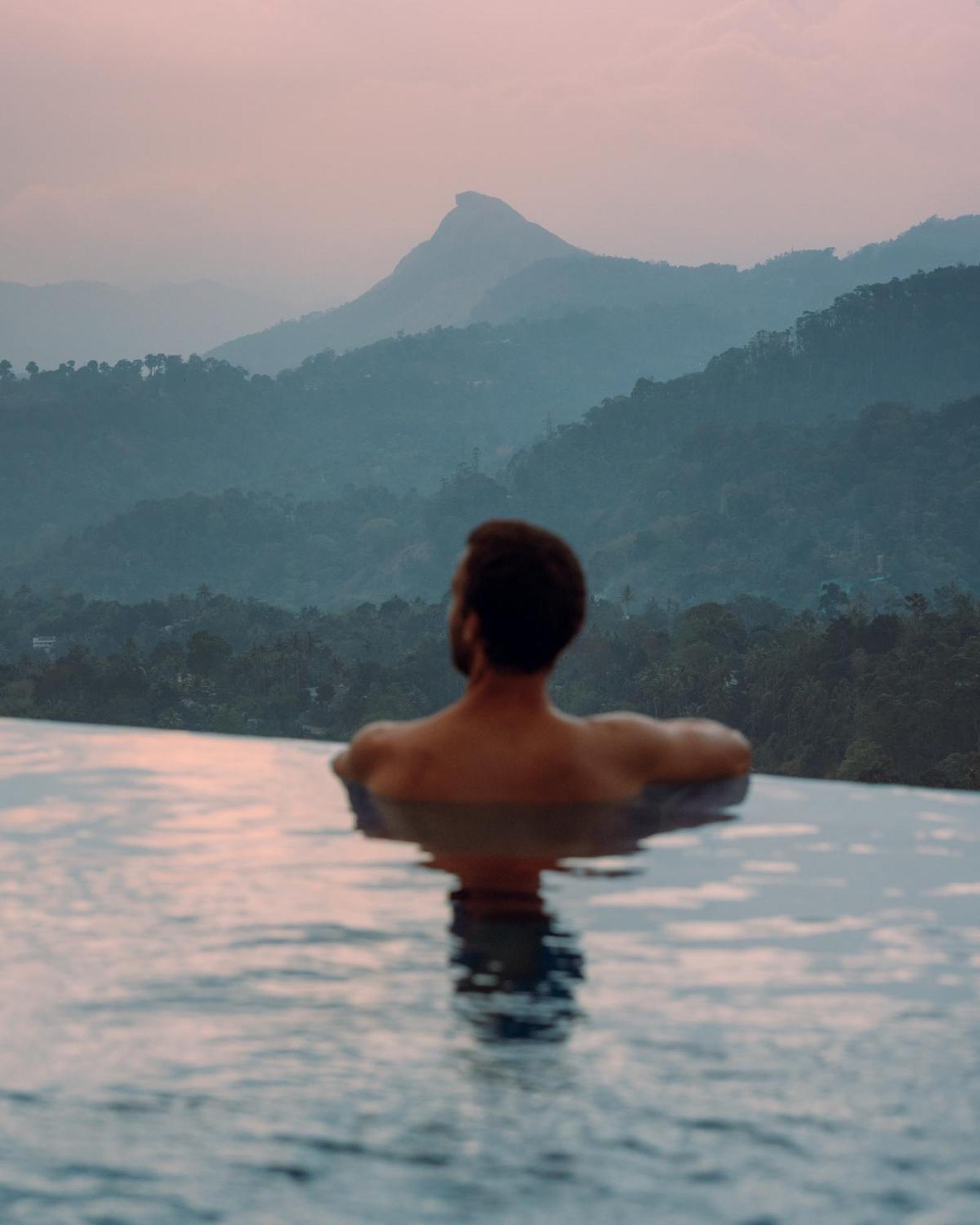 The Panoramic Getaway Hotel Munnar Exterior photo A man in a swimming pool